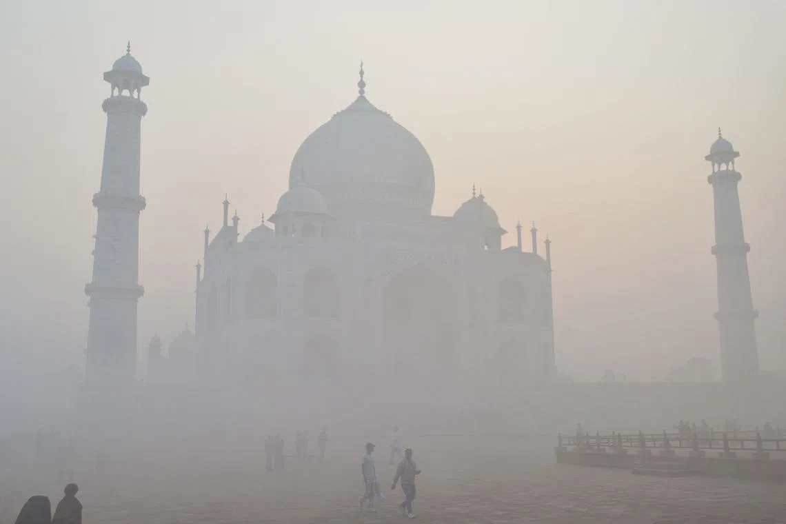 Tourist visiting the Taj Mahal amid heavy smog conditions in Agra on Nov 23, 2023.