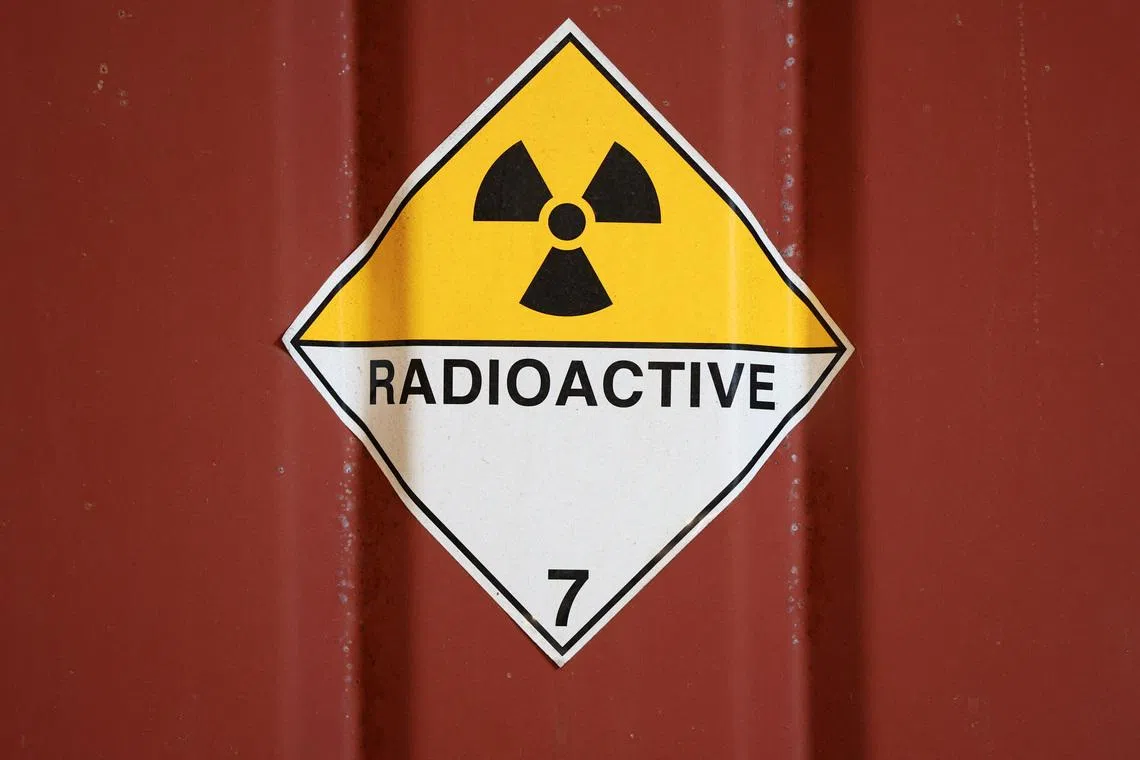 A radioactive sign is stuck to a container in the low-level waste vaults at the Dounreay nuclear site in Dounreay, Scotland, Britain November 25, 2025. REUTERS/Russell Cheyne
