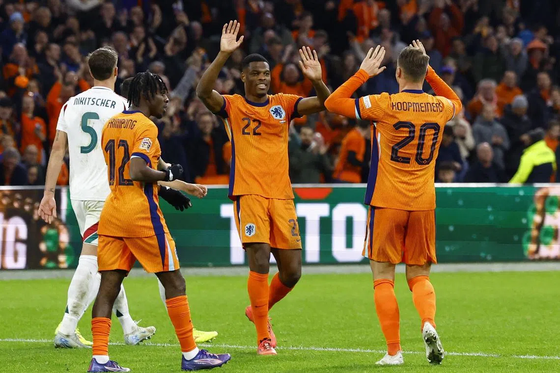 Netherlands' Teun Koopmeiners celebrates scoring their fourth goal with Denzel Dumfries.