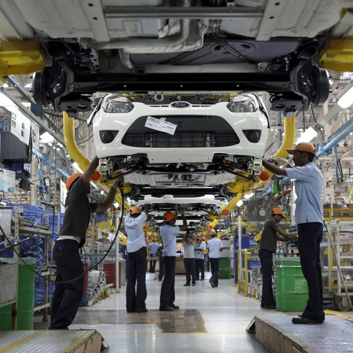 Ford Motor Co. employees work on the final assembly of vehicles at the Ford India Pvt. Maraimalai Nagar factory in Chengalpattu, India, on Tuesday, April 17, 2012. Ford's Maraimalai Nagar plant near Chennai in the southern state of Tamil Nadu makes the Figo hatchback, the Fiesta sedan and Endeavour SUV models.