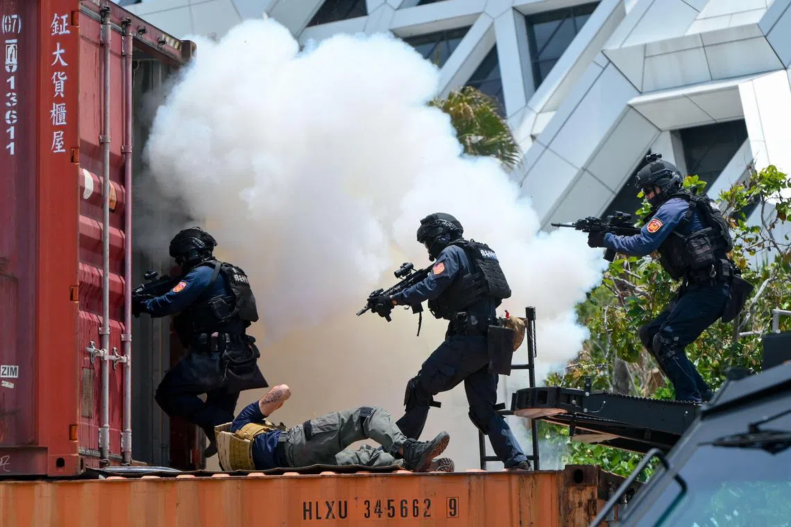 Taiwan special force troops enter a container during a coast guard drill in Kaohsiung on June 10, 2023. (Photo by Sam Yeh / AFP)