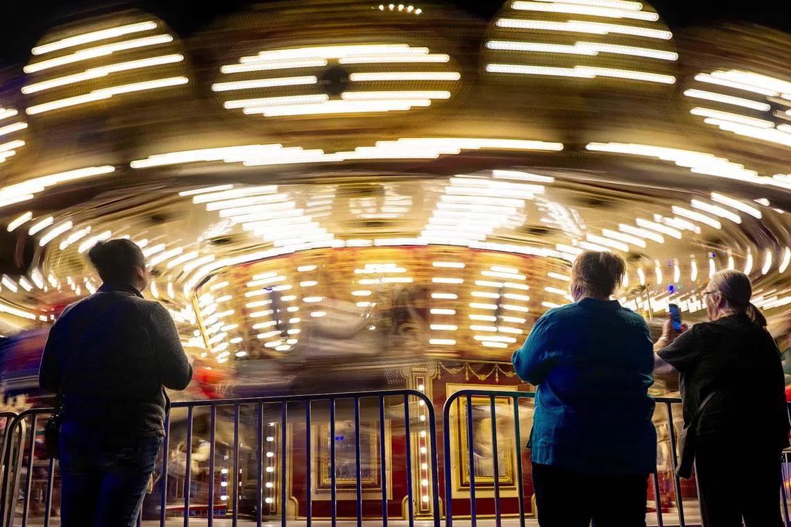 People watching the merry-go-round during the Austin Trail of Lights festival at Zilker Metropolitan Park on Dec 14, 2023 in Austin, Texas. 