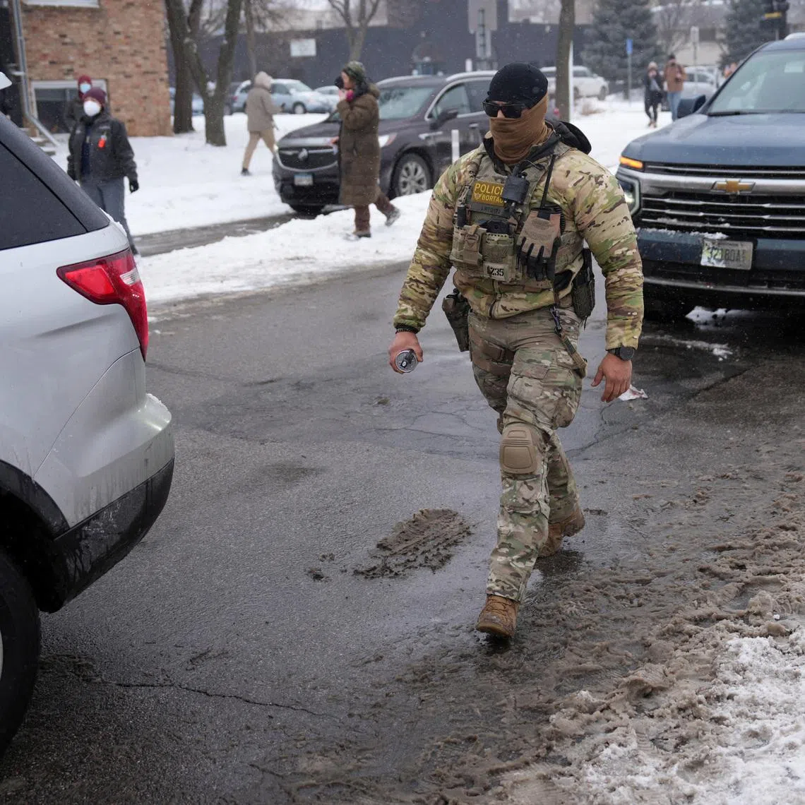 A federal agent walks while immigration enforcement continues after a U.S. Immigration and Customs Enforcement (ICE) agent fatally shot Renee Nicole Good on January 7 during an immigration raid, in Minneapolis, Minnesota, U.S., January 21, 2026. REUTERS/Leah Millis