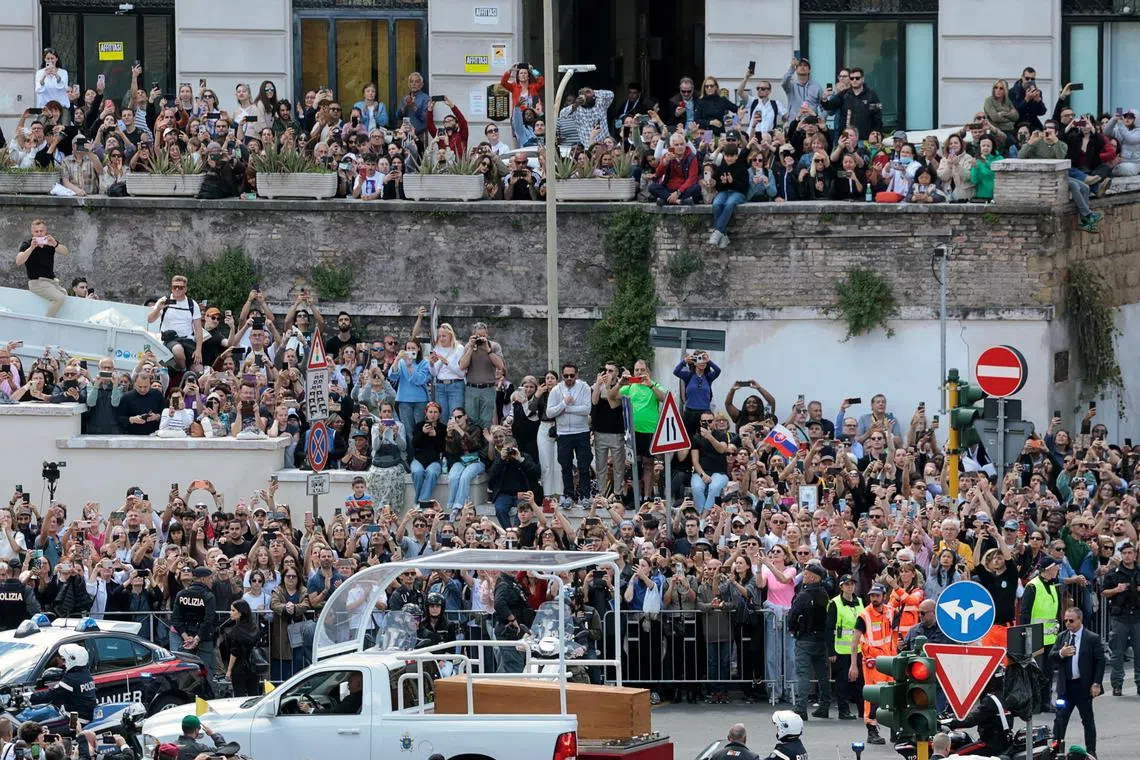 A hearse carrying the coffin of Pope Francis making its way to the Papal Basilica of Saint Mary Major (Santa Maria Maggiore) on the day of his funeral, as seen from the Vatican, April 26, 2025. 