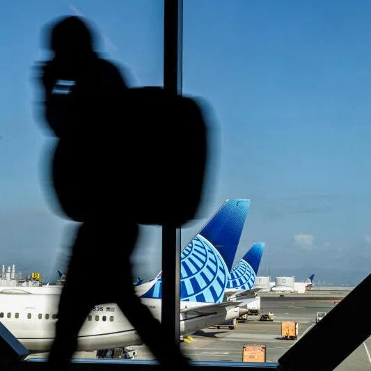 A passenger walks through San Francisco International Airport in California. Tech leaders have warned against targeting H-1B visas, citing a shortage of domestic talent for key technology jobs.