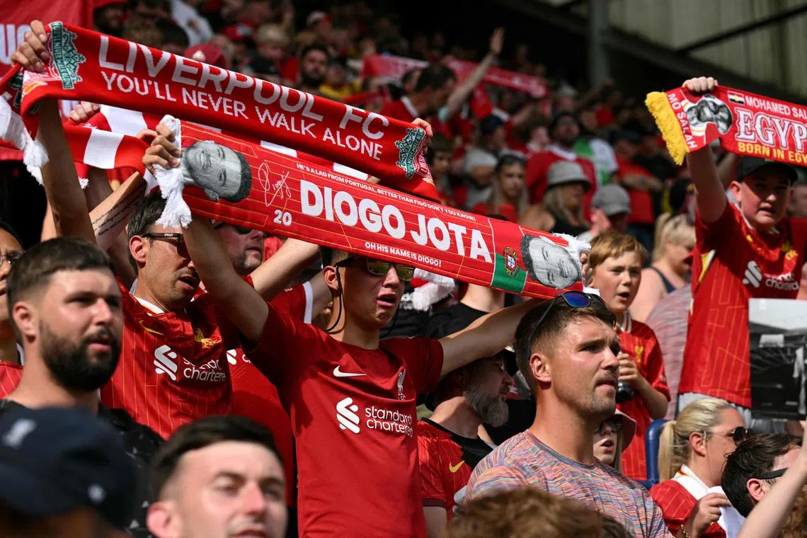 Fans remember Liverpool's late Portuguese attacker Diogo Jota following the pre-season friendly football match between Preston North End and Liverpool at Deepdale stadium in Preston, north-west England on July 13, 2025. Liverpool are to retire Jota's No. 20 shirt in honour of the Portugal forward who was killed in a car crash on July 3. 