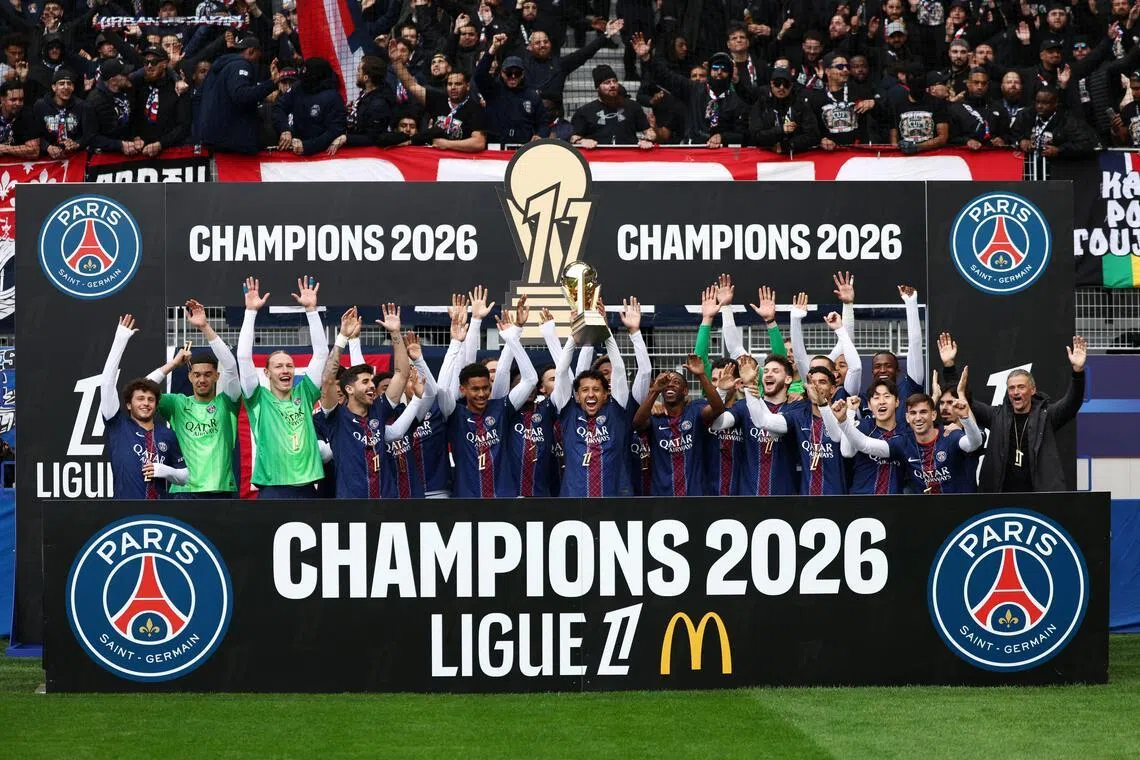 Soccer Football - Ligue 1 - Paris FC v Paris St Germain - Stade Jean-Bouin, Paris, France - May 17, 2026
Paris St Germain's Marquinhos lifts the trophy as he celebrates winning Ligue 1 with teammates before the match REUTERS/Tom Nicholson     TPX IMAGES OF THE DAY     