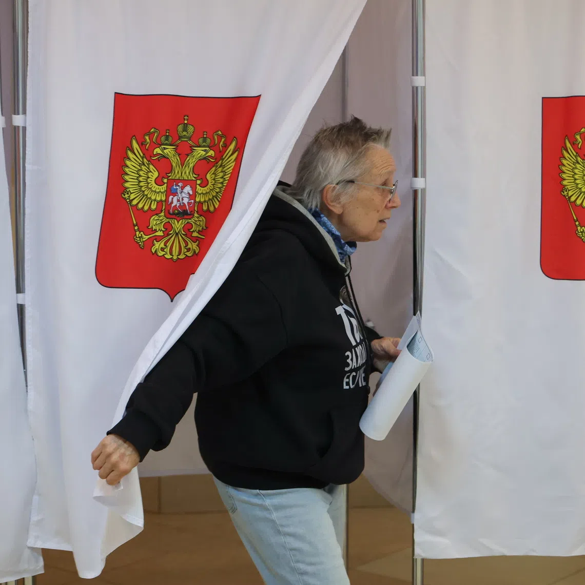A woman casts her ballot on the last day of voting on Sept 20 at a polling station in Podolsk, Moscow, Russia.