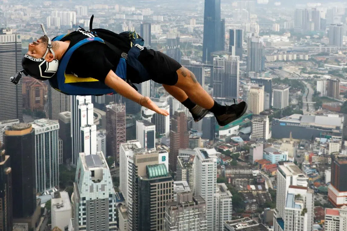 A base jumper leaps off the Kuala Lumpur Tower during the annual KL Tower International Jump Malaysia 2023 at Kuala Lumpur, Malaysia, Feb 3, 2023. 