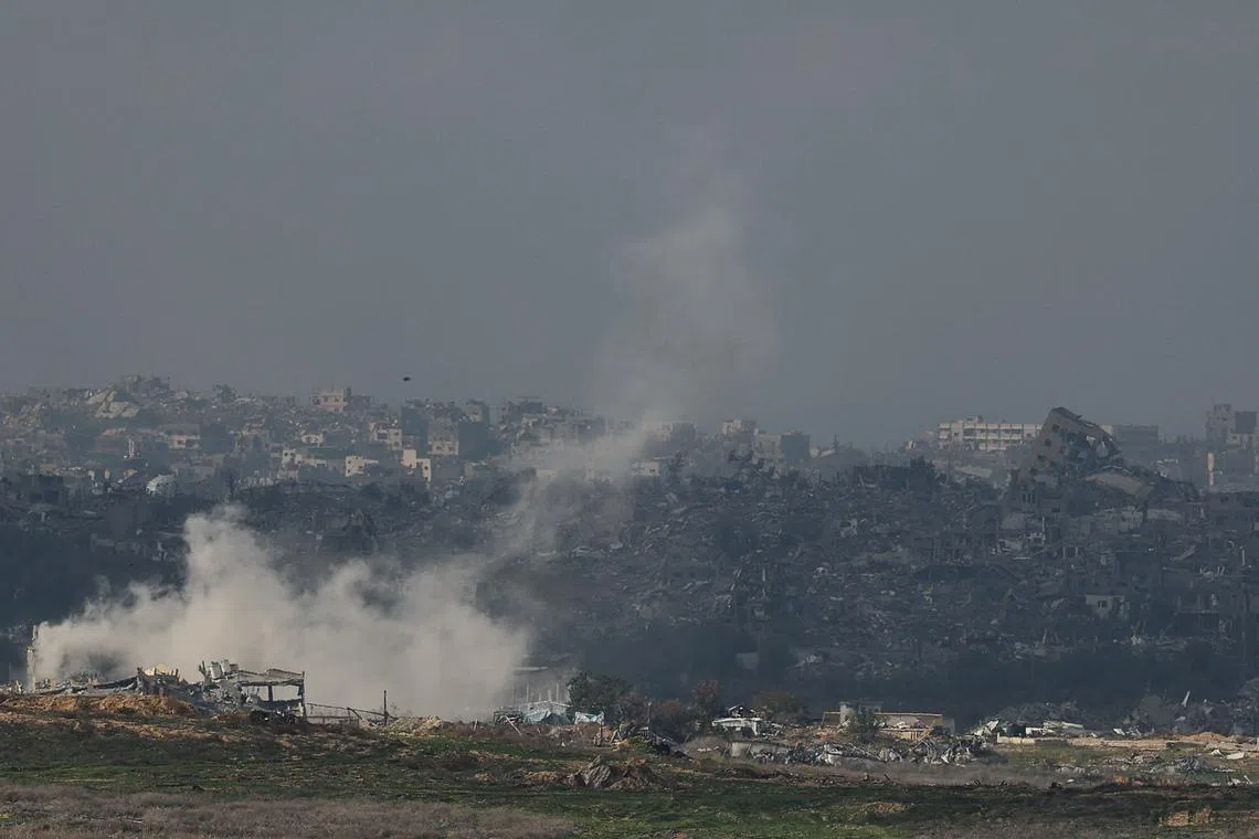 Smoke rises following an Israeli strike, as buildings lie in ruin in Beit Hanoun, in the Gaza Strip, amid the ongoing conflict between Israel and Hamas, as seen from southern Israel, January 12, 2025. REUTERS/Kai Pfaffenbach