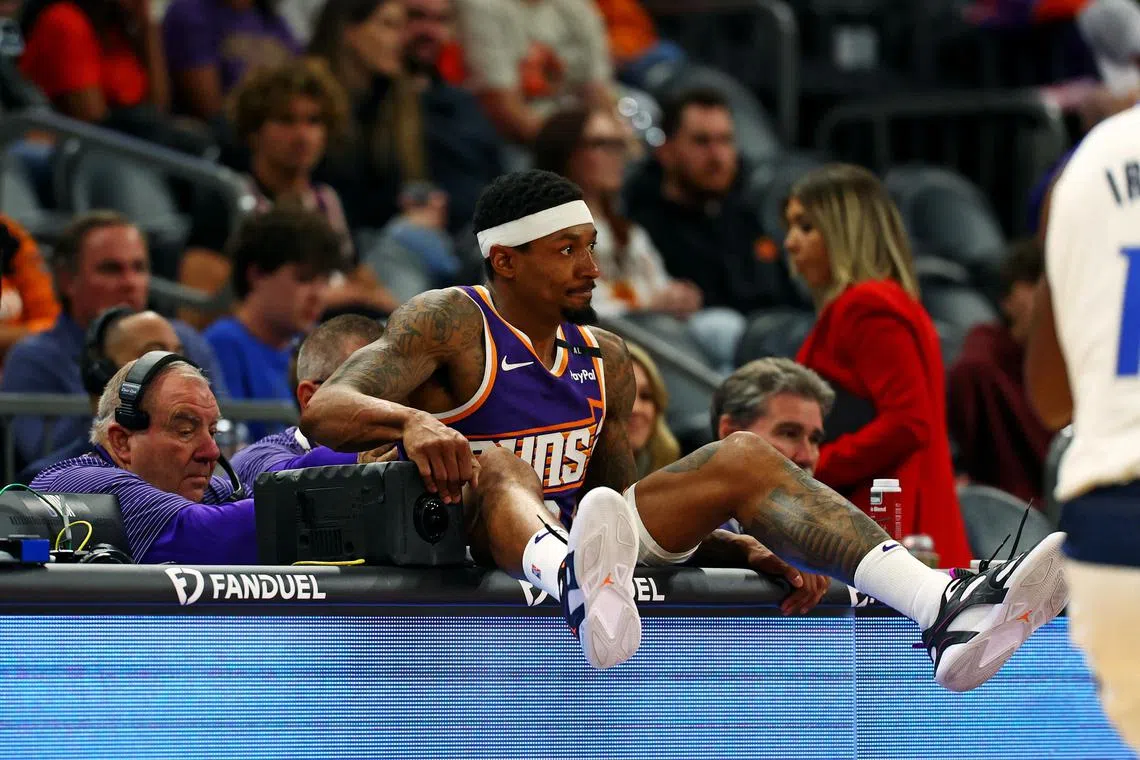 Phoenix Suns guard Bradley Beal falling into the scorers table during the fourth quarter against the Dallas Mavericks at Footprint Center on Dec 27.