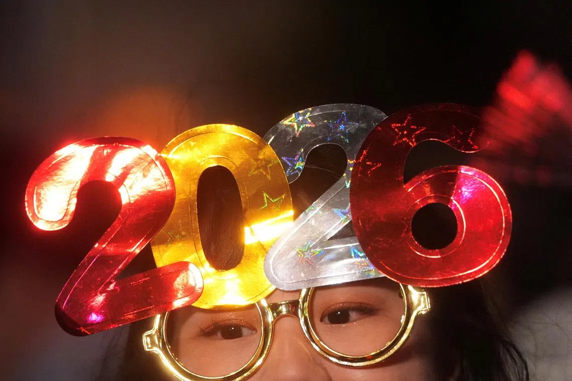 A person wearing 2026 glasses during the countdown for the New Year at Central in Hong Kong, China, on Dec 31, 2025. 