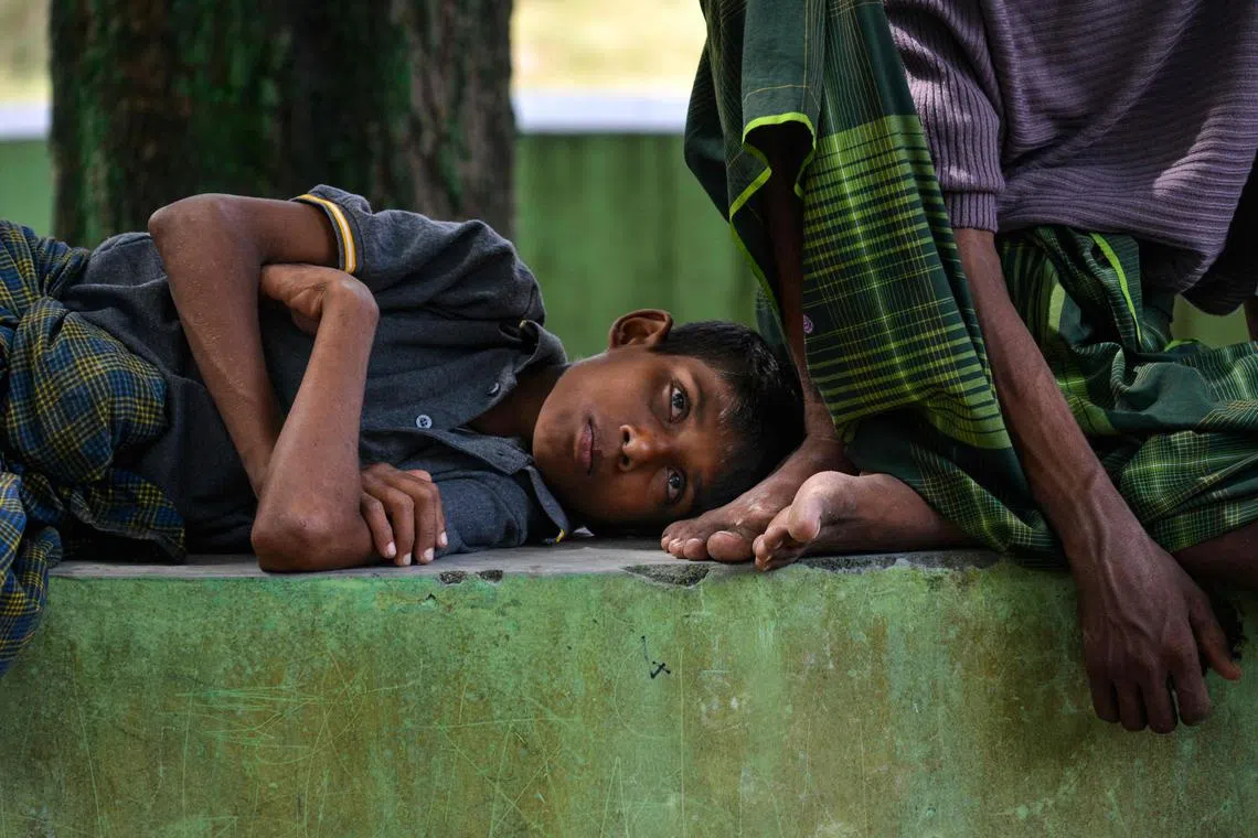 A Rohingya refugee rests in a temporary shelter following his arrival by boat in Laweueng, Aceh province on December 27, 2022.