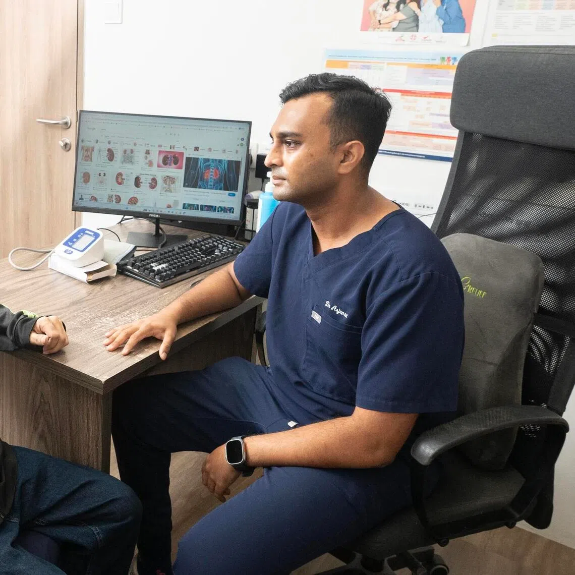 Dr Arjunan Kumaran, 34, with his patient, Mr Syafic Bin Omar, 40, at Intemedical Tampines on Oct 28.