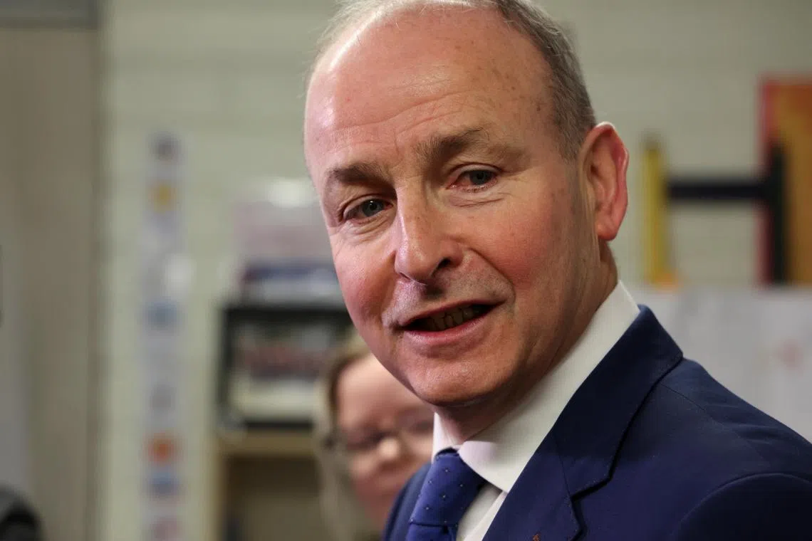 FILE PHOTO: Ireland's Tanaiste (Deputy Prime Minister) and leader of Fianna Fail, Micheal Martin speaks to the media after voting at a polling station in St. Anthony's Boys National school, during Ireland's general election, in Cork, Ireland, November 29, 2024. REUTERS/Damien Eagers/File Photo