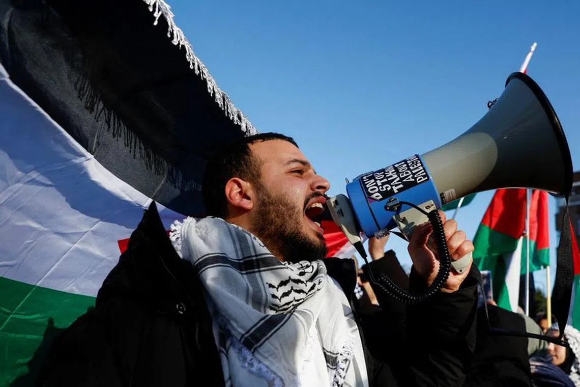 A person shouts slogans during a pro-Palestinian demonstration outside the International Court of Justice.