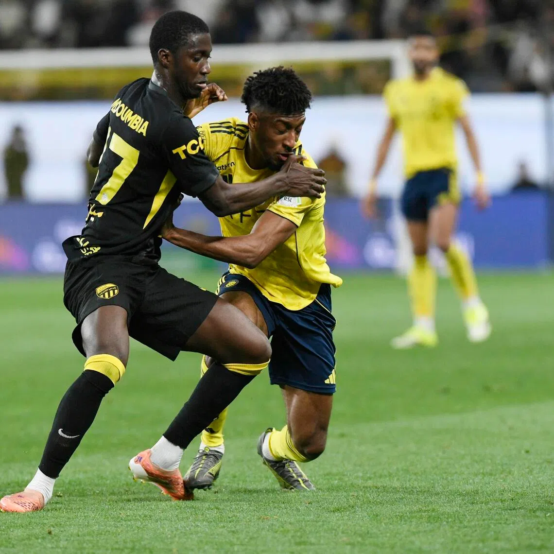 Al Ittihad's Mahamadou Doumbia (left) challenging Al Nassr's Kingsley Coman oin their Saudi Pro League game at Al Awwal Park in Riyadh, Saudi Arabia on Feb 6, 2026.