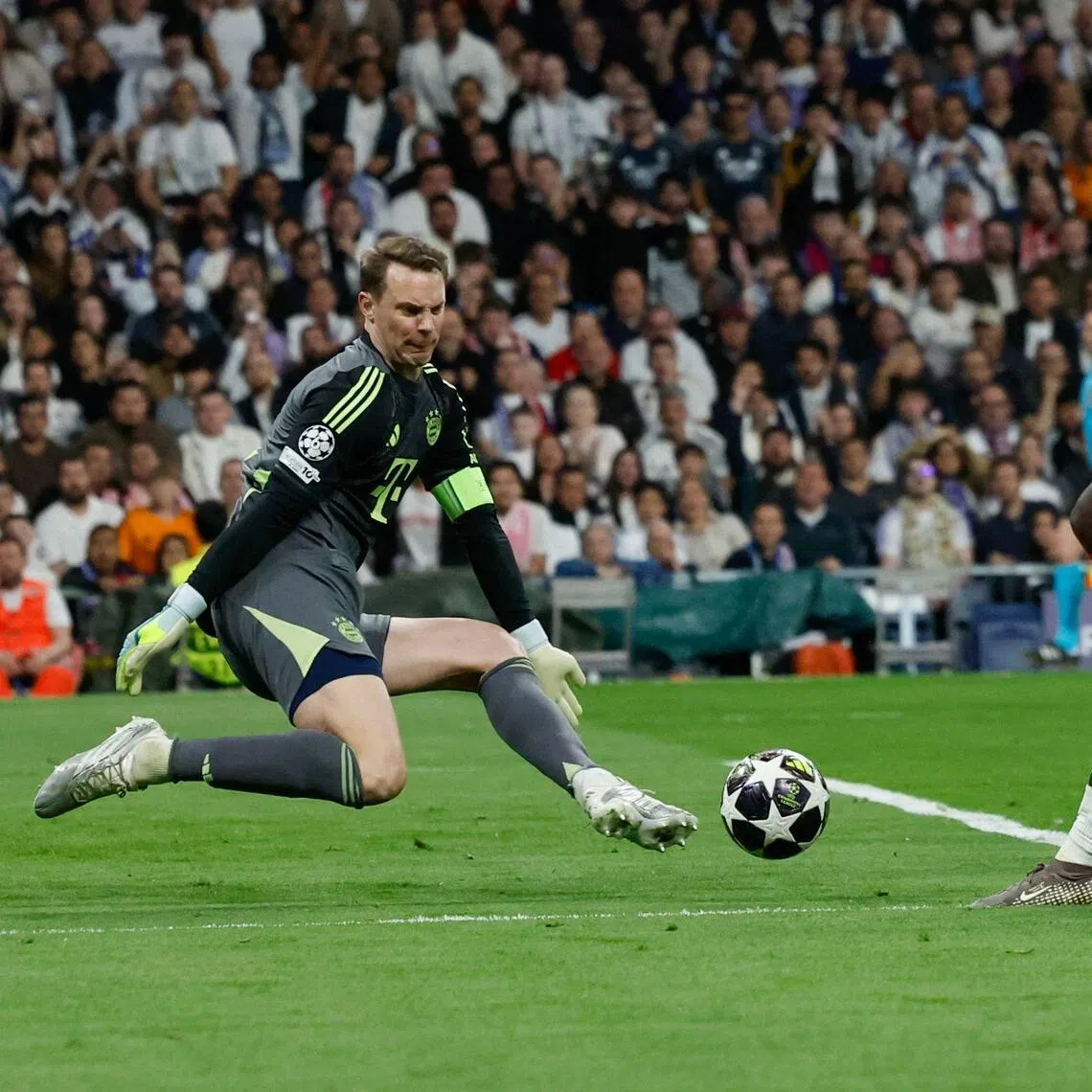 Real Madrid's French forward Kylian Mbappe being denied by German goalkeeper Manuel Neuer during Bayern Munich's 2-1 Champions League quarter-final, first-leg win at the Santiago Bernabeu Stadium in Madrid on April 7, 2026.