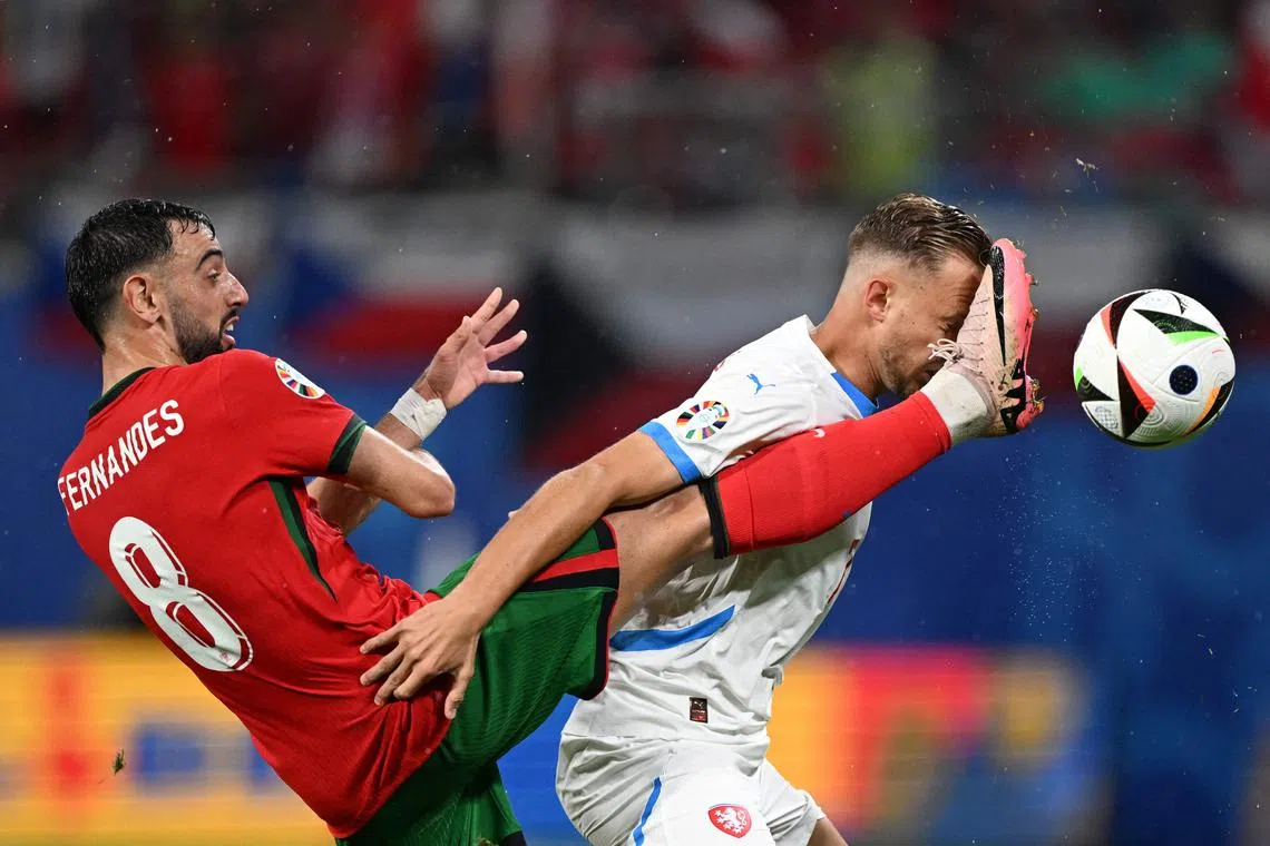 Portugal's midfielder Bruno Fernandes (left) vying for the ball with the Czech Republic's midfielder Antonin Barak during the Uefa Euro 2024 Group F football match at Leipzig Stadium in Germany on June 18, 2024.