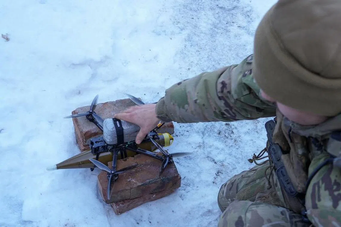 FILE PHOTO: A Ukrainian serviceman of the Rarog UAV squadron of the 24th Separate Mechanized Brigade places a first person view (FPV) drone with an attached shell for an RPG-7 grenade launcher to a launch point, at a position near the town of Horlivka, amid Russia's attack on Ukraine, in Donetsk region, Ukraine January 17, 2024. REUTERS/Inna Varenytsia/File Photo