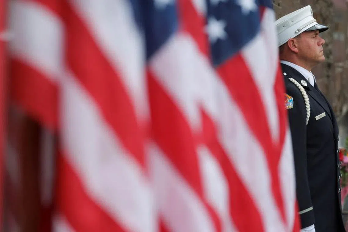 A New York City Fire Department firefighter stands at the Firefighter memorial, on the day of the 22nd anniversary of the September 11, 2001 attacks on the World Trade Center, in New York City, U.S., September 11, 2023. REUTERS/Andrew Kelly