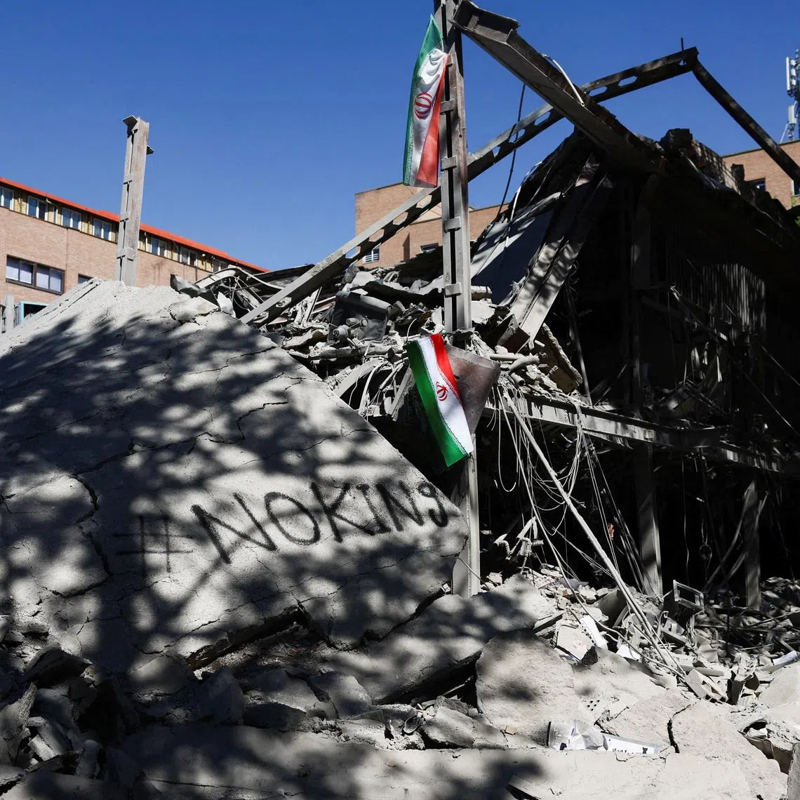 FILE PHOTO: An Iranian flag hangs amidst the rubble of a building of the Sharif University of Technology, which was damaged in a strike, amid the U.S.-Israeli conflict with Iran, in Tehran, Iran, April 7, 2026. Majid Asgaripour/WANA (West Asia News Agency) via REUTERS