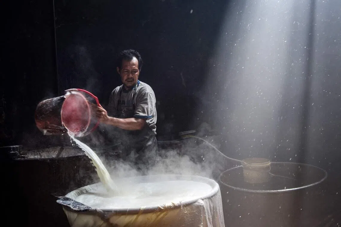 A worker cooking soybean paste to produce traditional tofu in Bandung, West Java, Indonesia on April 1, 2026. 
