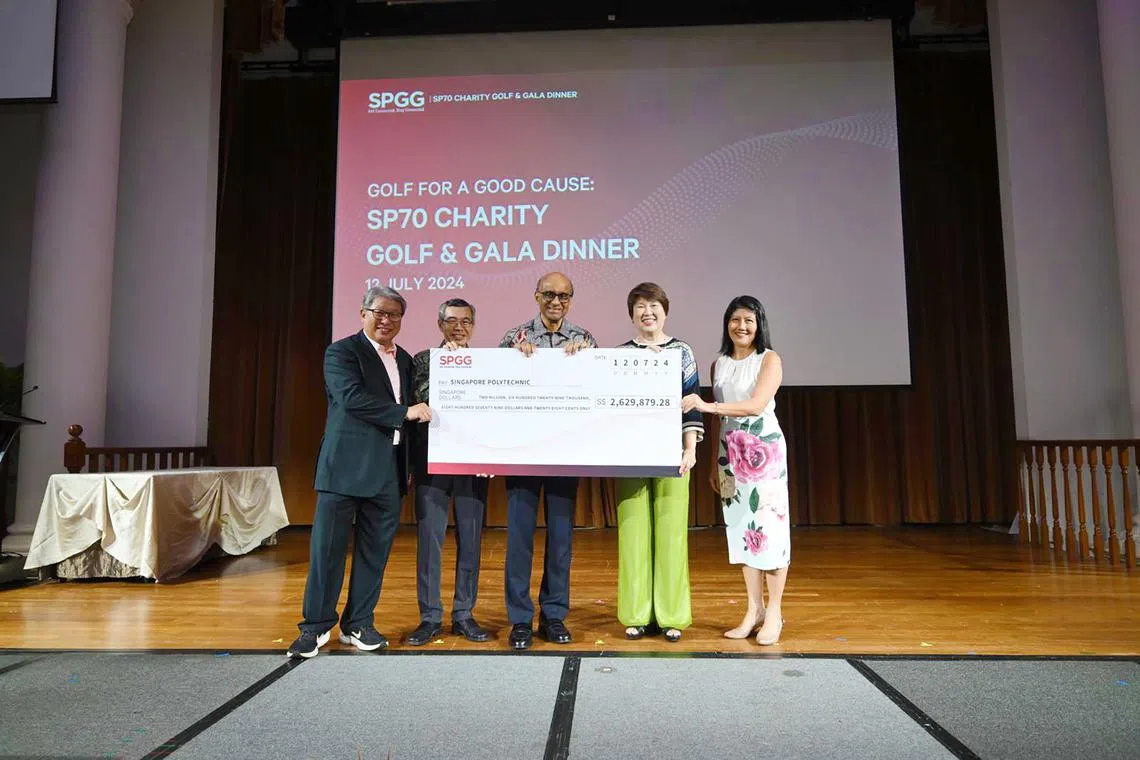 (From left) President of Singapore Polytechnic Graduates' Guild Jimmy Lim, Singapore Polytechnic principal and CEO Soh Wai Wah, President Tharman Shanmugaratnam, SP Board of Governors chariman Janet Ang and National Council of Social Service CEO Tan Li San with the the cheque of $2,629,879.28 for needy students.
