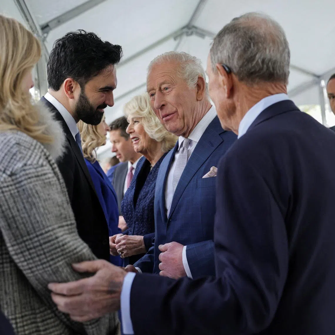 It is unclear whether Mr Mamdani (second from left) followed through and brought up the contentious subject with King Charles when the two met.