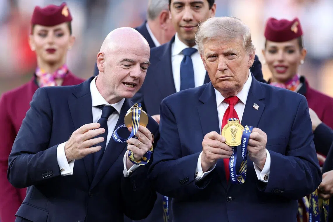 EAST RUTHERFORD, NEW JERSEY - JULY 19: FIFA President Gianni Infantino and U.S. President Donald Trump watch the medal at the award ceremony following the FIFA World Cup 2026 Final match between Spain and Argentina at New York New Jersey Stadium on July 19, 2026 in East Rutherford, New Jersey.   Justin Setterfield/Getty Images/AFP (Photo by Justin Setterfield / GETTY IMAGES NORTH AMERICA / Getty Images via AFP)