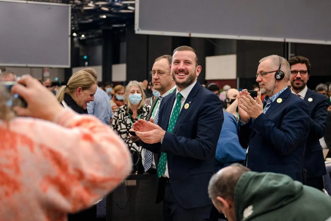EU's Commissioner for the Environment, Oceans and Fisheries Virginijus Sinkevicius (centre) and other delegates applauding after the COP15 agreements were adopted on Dec 19, 2022.