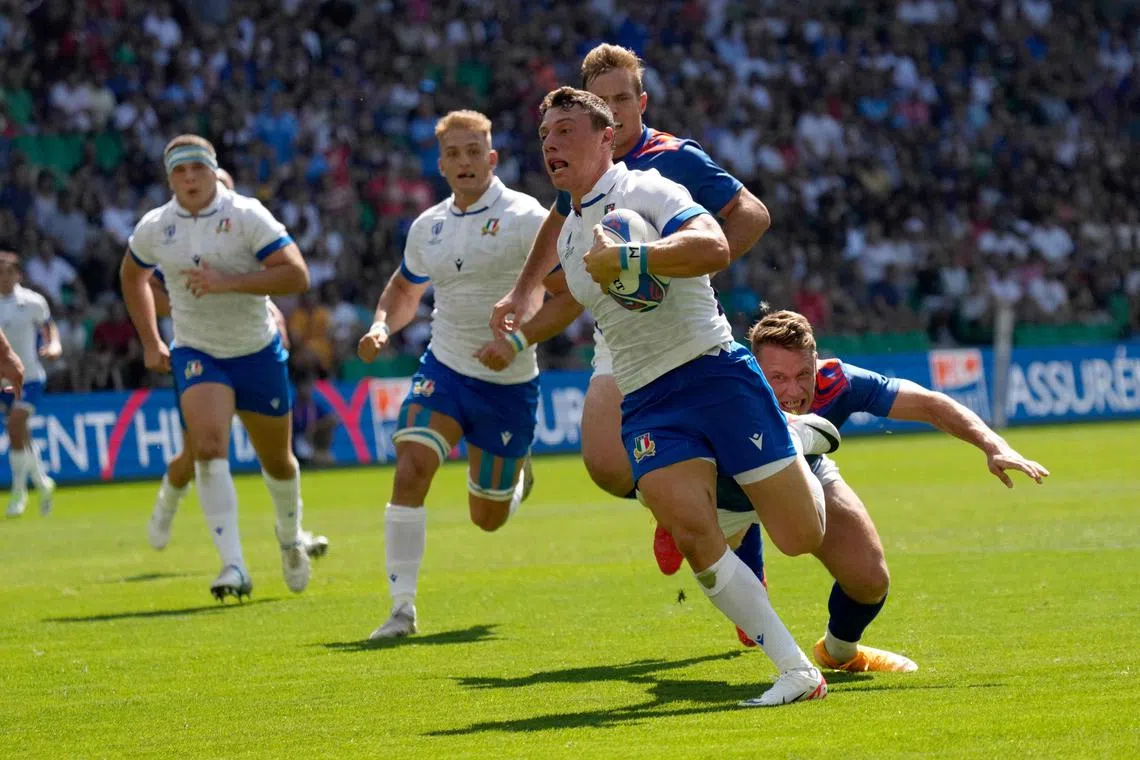 Italy's Paolo Garbisi runs to score the team's second try during the 52-8 Rugby World Cup win over Namibia.