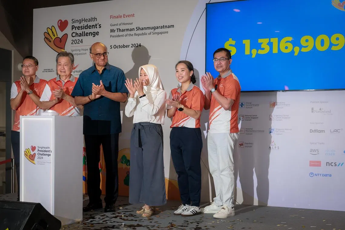 (From left) SingHealth group chief executive Ng Wai Hoe, Group, SingHealth chairman Cheng Wai Keung, President Tharman Shanmugaratnam, Minister of State for Health Rahayu Mahzam, SingHealth President's Challenge 2024 chair Eileen Poon, Chair and National Cancer Centre Singapore chief executive Lim Soon Thye unveiling of the total amount of funds raised by SingHealth for the President's Challenge 2024 on Oct 5, 2024.