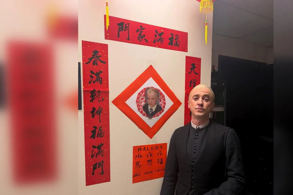 Tom Felton shared on social media, on Feb 19, a photo of himself with CNY couplets and a photo of Draco Malfoy.