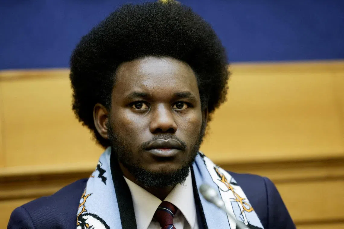 FILE PHOTO: David Yambio from South Sudan, a migrant who was allegedly maltreated by Libyan ICC suspect Osama Elmasry Njeem, looks on as he holds a press conference with other migrants who were allegedly maltreated, at the Parliament in Rome, Italy, January 29, 2025. REUTERS/Remo Casilli/File Photo