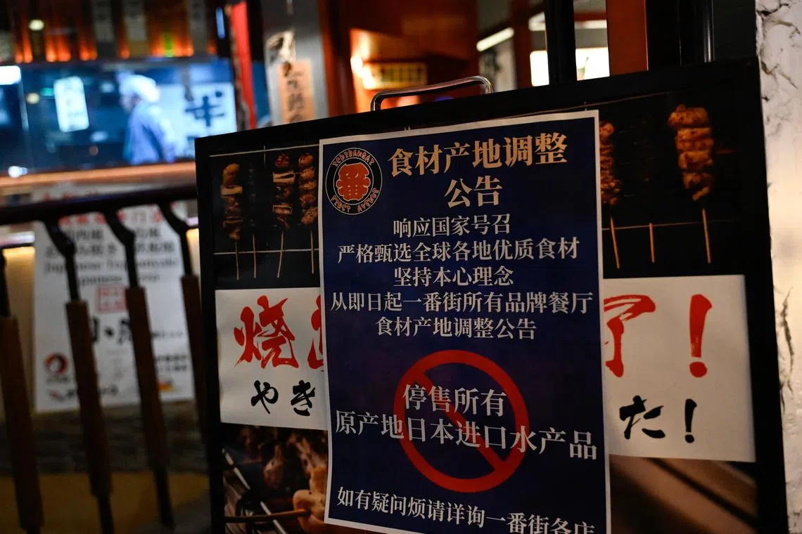 A sign calling for the suspension of Japanese seafood products is seen in Beijing in August 2023. Increasing tensions between the two countries has seen trade cratering.