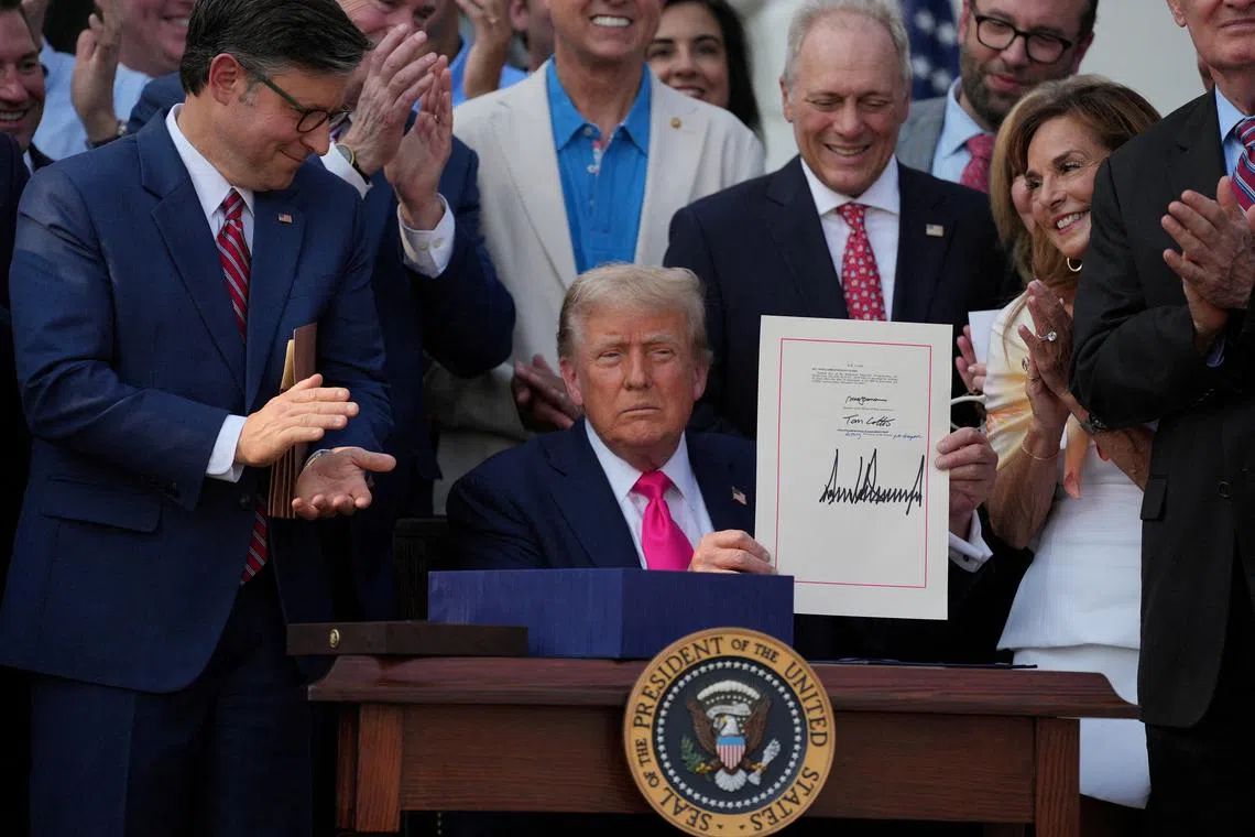 U.S. President Donald Trump presents a sweeping spending and tax legislation, known as the \"One Big Beautiful Bill Act,\" after he signed it, at the White House in Washington, D.C., U.S., July 4, 2025. REUTERS/Leah Millis