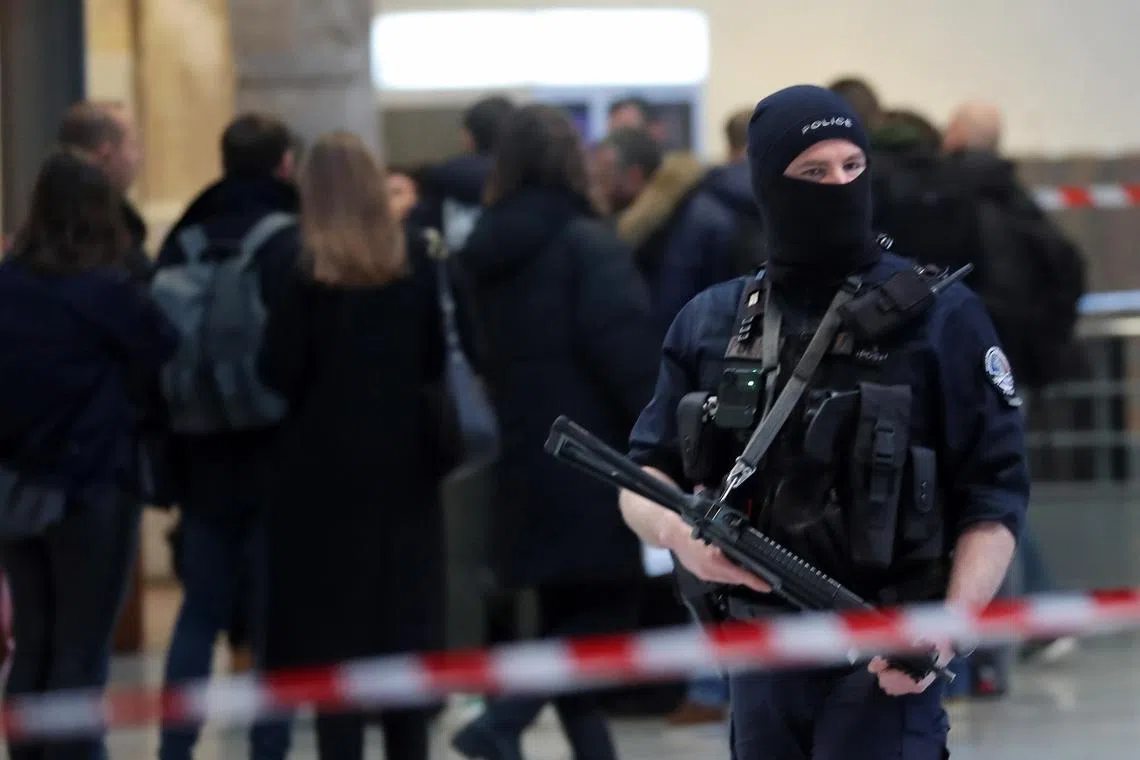 Police officers guard at Paris' Gare du Nord after securing the scene following a knife attack, on Jan 11, 2023.