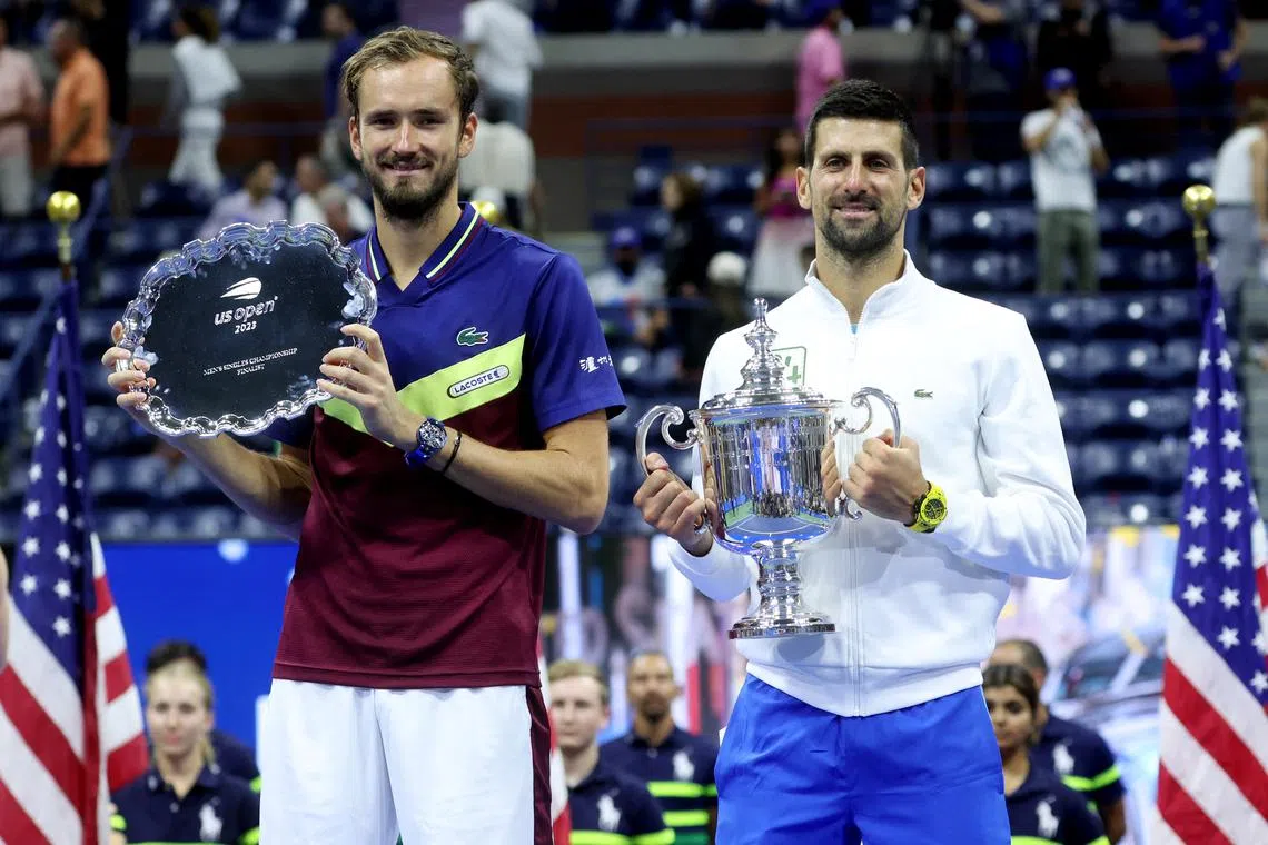 FILE PHOTO: Tennis - U.S. Open - Flushing Meadows, New York, United States - September 10, 2023 Serbia's Novak Djokovic celebrates with the trophy after winning the U.S. Open beside second place Russia's Daniil Medvedev REUTERS/Mike Segar