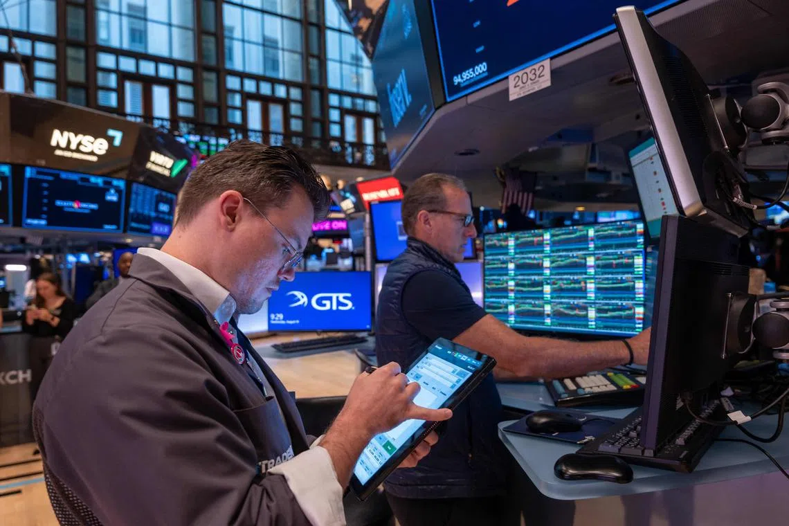 Traders work on the floor of the New York Stock Exchange, in New York City. 