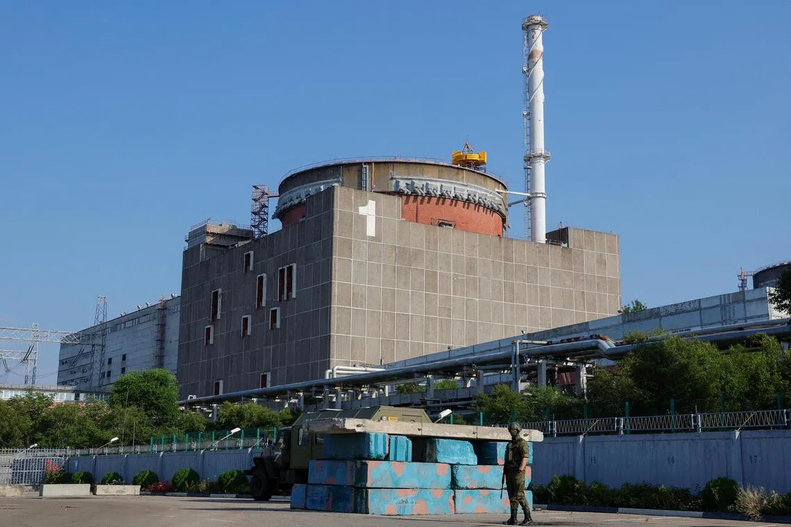 A Russian soldier standing guard at a checkpoint near Ukraine’s Zaporizhzhia nuclear power plant in 2023. Russian forces seized ⁠the plant - Europe’s largest - in ​2022.