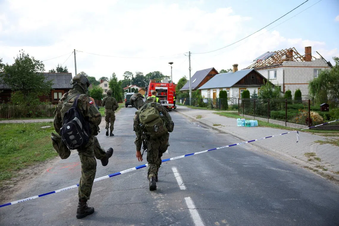 Soldiers walk next to a site where a roof of a house was destroyed, after Russian drones violated Polish airspace during an attack on Ukraine, with some being shot down by Poland with the backing from its NATO allies, in Wyryki, Lublin Voivodeship, Poland, September 10, 2025. REUTERS/Kacper Pempel