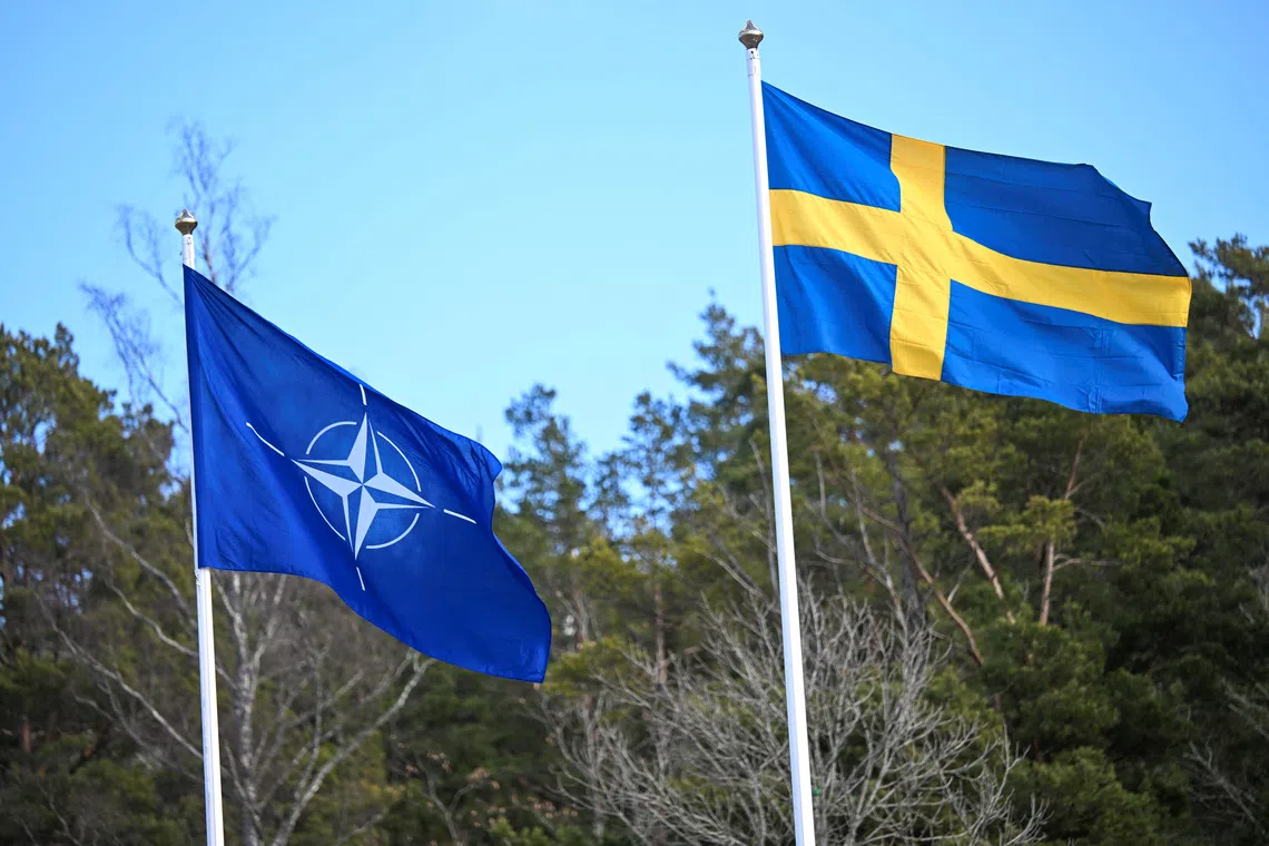 The NATO flag is raised at a ceremony at the Musko navy base near Stockholm, Sweden, March 11, 2024. TT News Agency/Fredrik Sandberg/via REUTERS