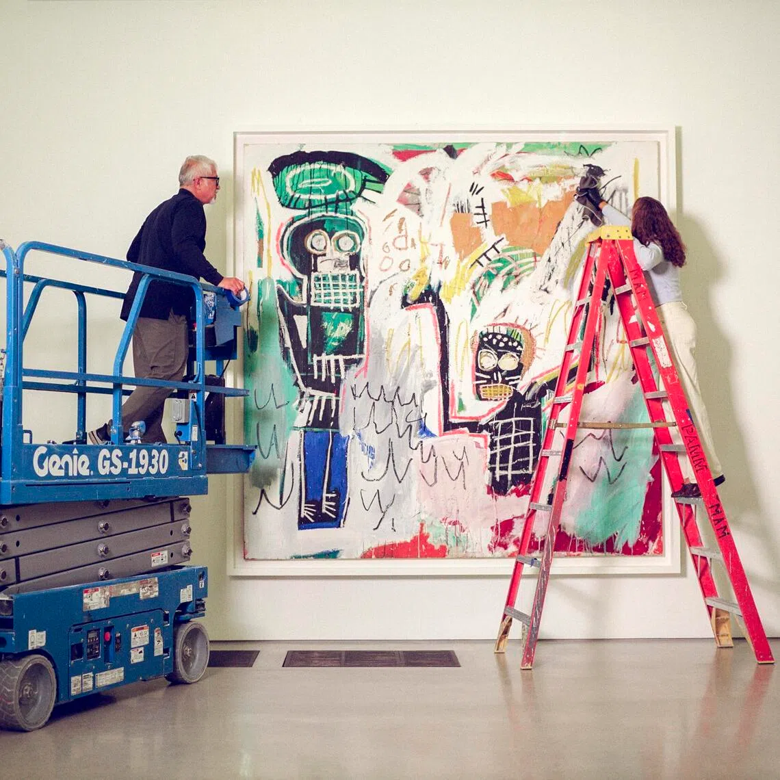 Basquiat’s Untitled (Baptismal), painted in 1982, receives a final dusting before the public opening of the exhibition, Basquiat: Figures, Signs, Symbols, at the Perez Art Museum Miami in June. Ten of Ken Griffin’s Basquiats are on loan to PAMM.