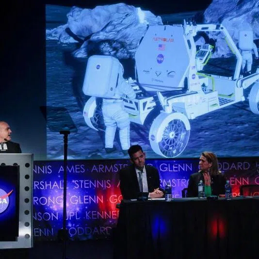 NASA Moon Base Program Executive Carlos Garcia-Galan (left) presenting concept animations of the Astrolab Crewed Lunar Vehicle on May 26 during a news conference with Administrator Jared Isaacman (second from left) at NASA headquarters in Washington DC.