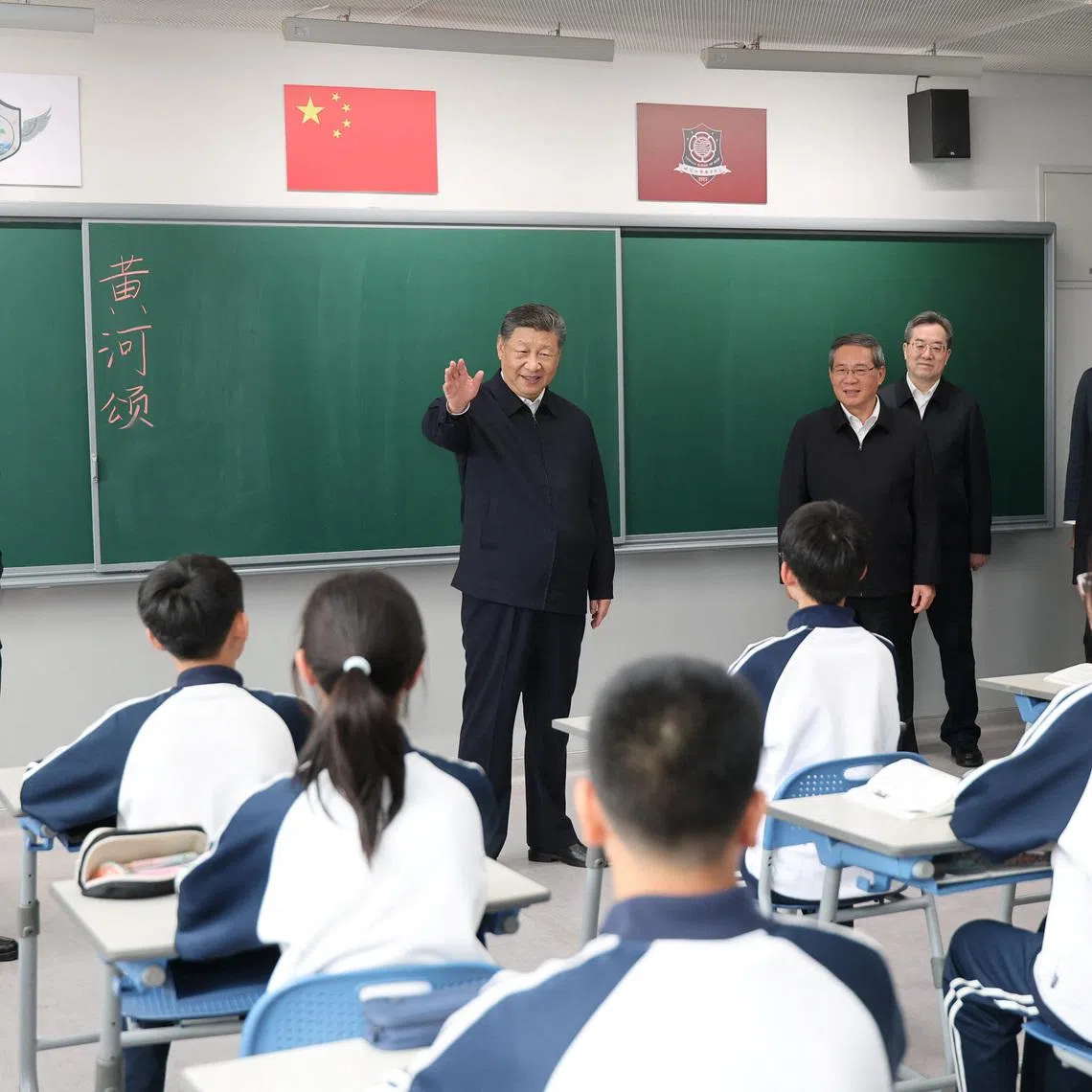 Chinese President Xi Jinping talks with students in a classroom at a high school, during an inspection tour of Xiongan New Area in Hebei province, China March 23, 2026. cnsphoto via REUTERS