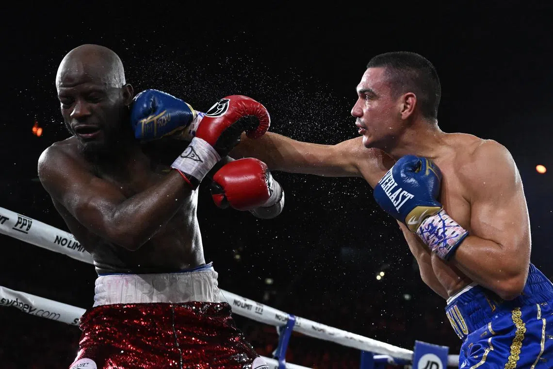 Australian boxer Tim Tszyu (right) in action against United States boxer Tony Harrison during their interim World Boxing Organization (WBO) super-welterweight world title fight at Qudos Bank Arena in Sydney. Tszyu stopped the American in the ninth round.