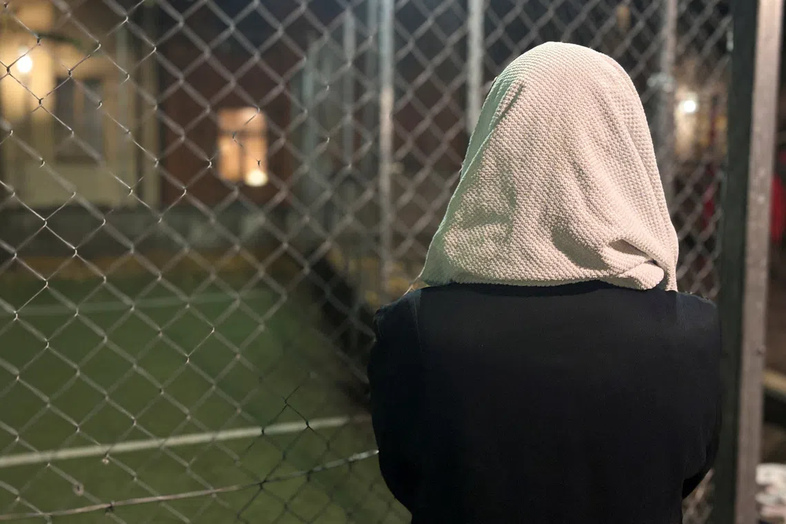 Elena Ibrahim, an immigrant who fled Sudan eight years ago, stands next to wire fencing in central Stockholm, Sweden, September 7, 2026. REUTERS/Johan Ahlander