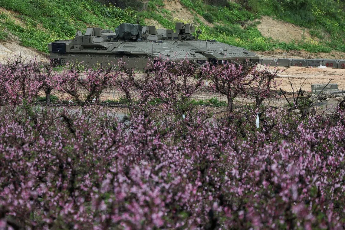Israeli military vehicles are parked on the Israeli side of the border with Lebanon, amid escalation between Iran-backed Hezbollah and Israel and the U.S.-Israeli conflict with Iran, in northern Israel, March 21, 2026. REUTERS/Tyrone Siu