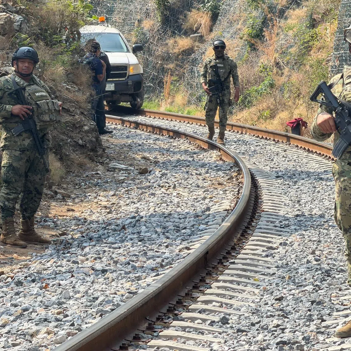 Members of the Mexican navy guard the site of train derailment on the Interoceanic Corridor of the Isthmus of Tehuantepec, a railway line connecting Mexico's Pacific and Gulf coasts, where several passengers were killed and injured in Chivela, Oaxaca state, Mexico December 29, 2025. REUTERS/Jose de Jesus Cortes